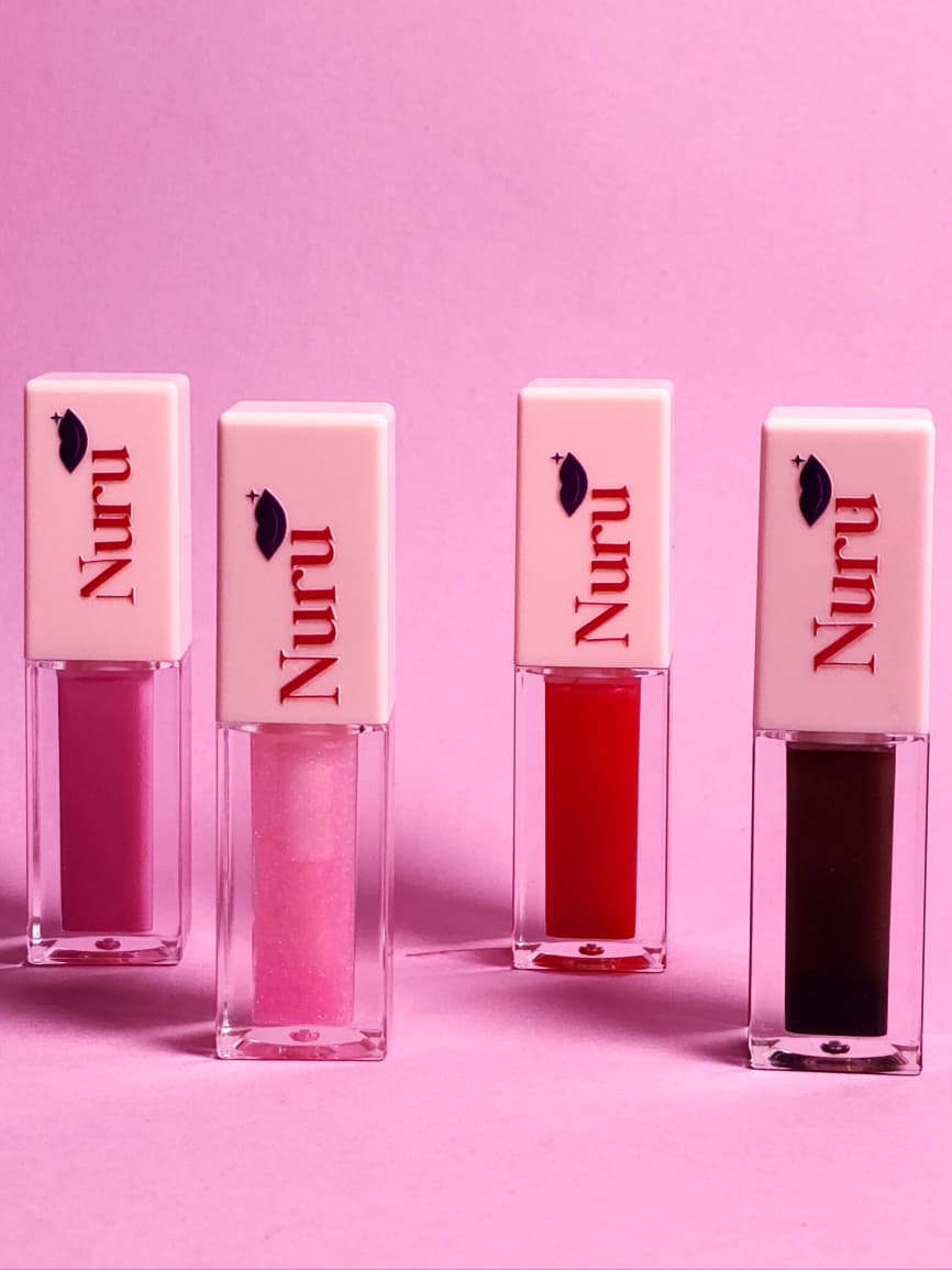 The Nuru lip gloss collection — four shades